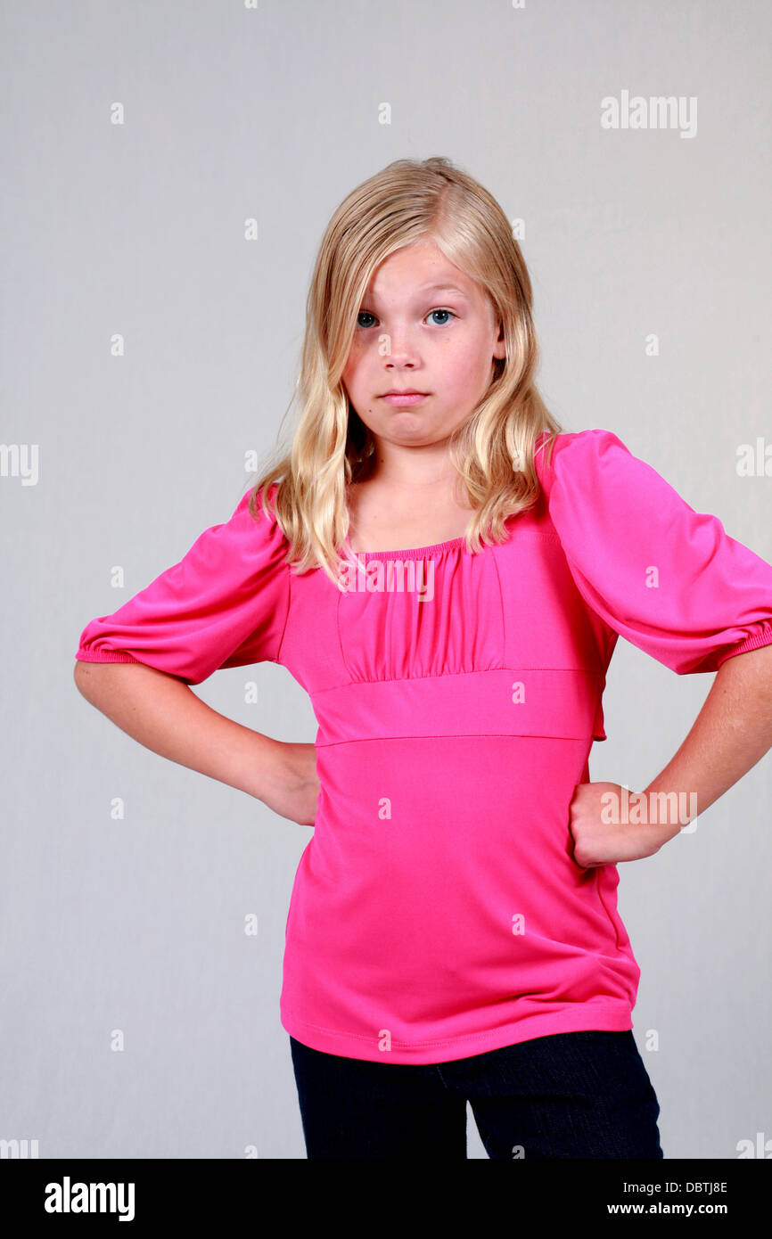 cute little blond girl with hands on hips Stock Photo Alamy