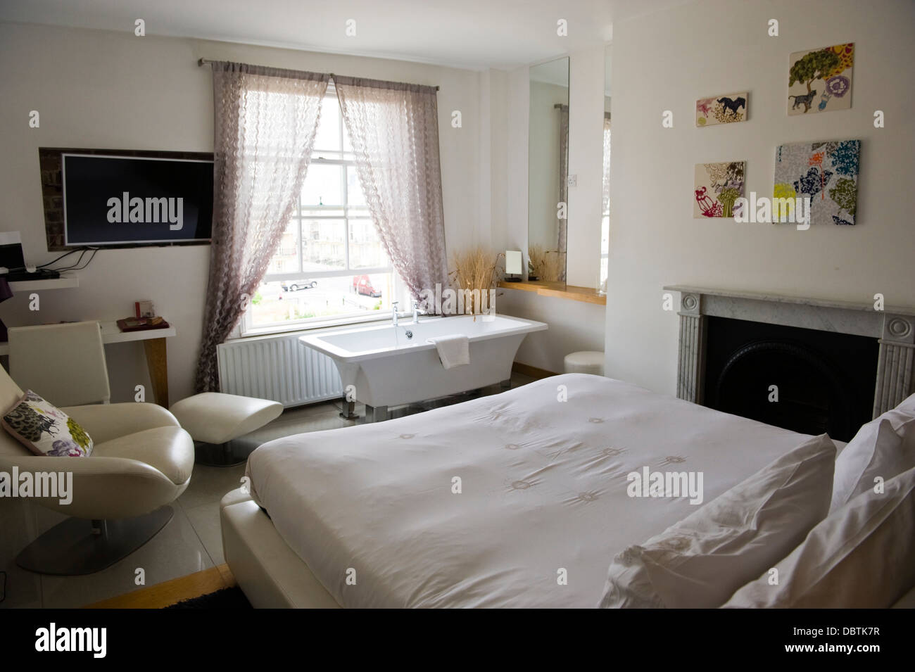 Bedroom Of Hotel With Bath Under Window In Brighton East Sussex England Uk Stock Photo Alamy