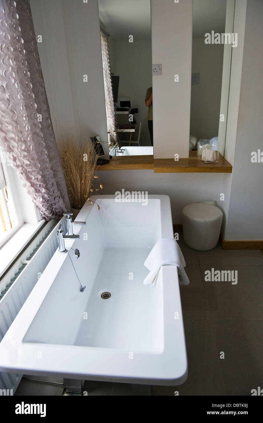 Bedroom of hotel with bath under window in Brighton East Sussex England ...