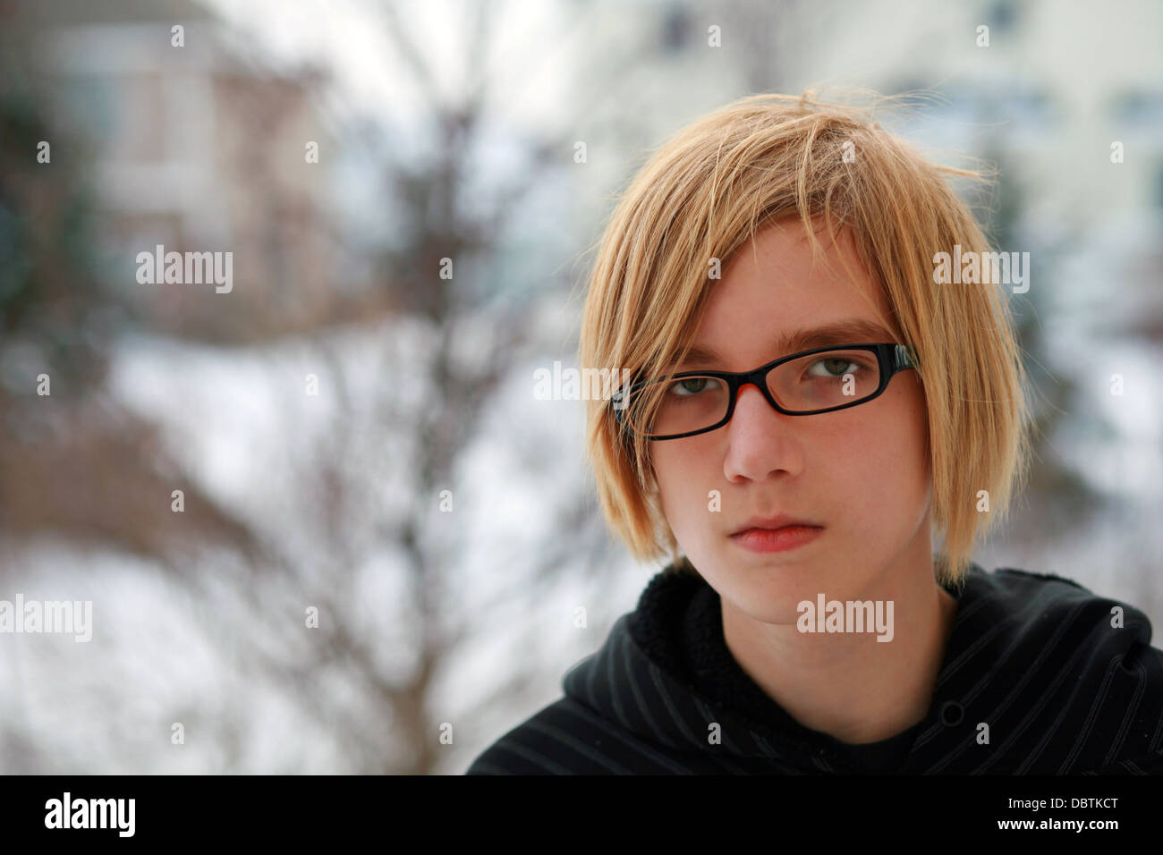 Closeup Of Sad Teen Boy With Blonde Hair And Glasses Stock Photo