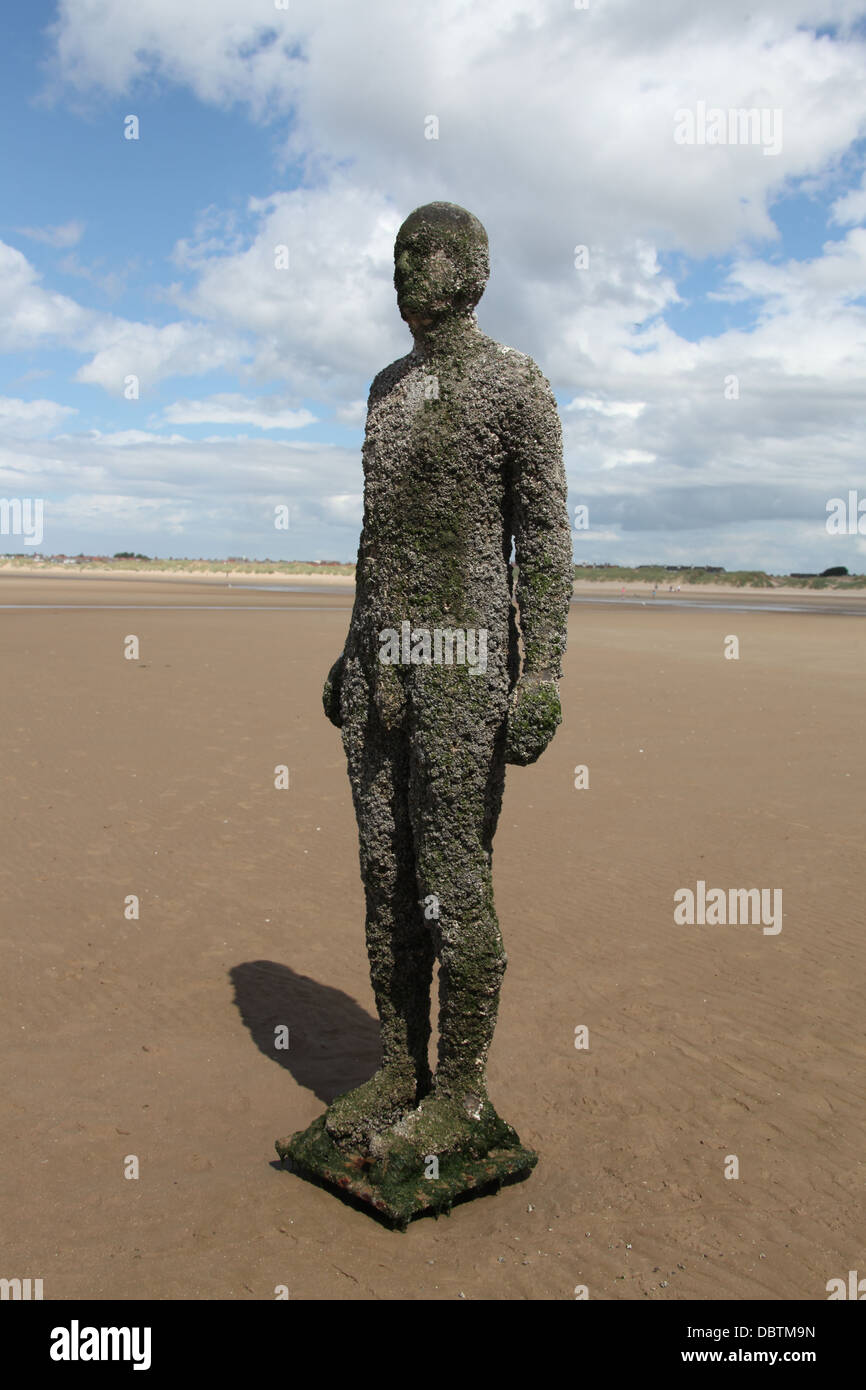 Another Place artwork statue on Crosby Beach in Lancashire Stock Photo
