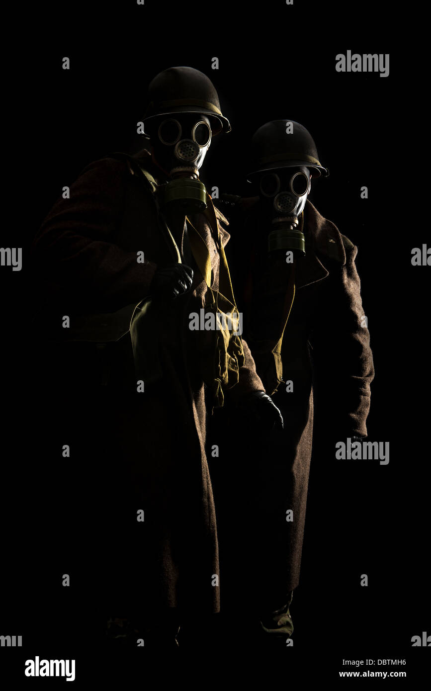 Soldiers with gas mask in a dark background Stock Photo