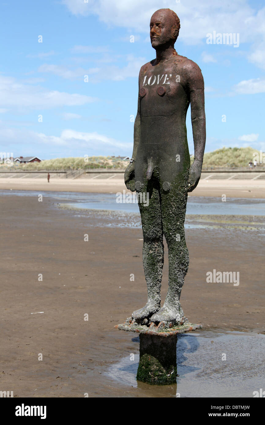 LOVE written on one of the Antony Gormley statues called Another Place