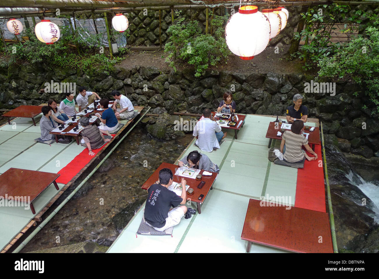 A 'kawadoko' dining deck built over a river running through Kibune in Kyoto, Japan. Stock Photo