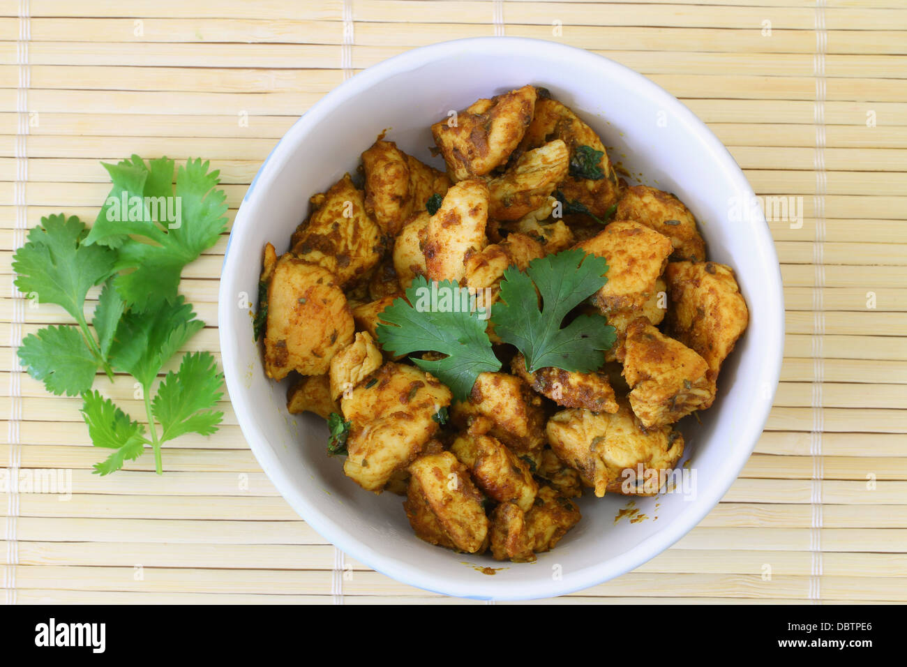 Spicy chicken with curry and coriander Stock Photo Alamy