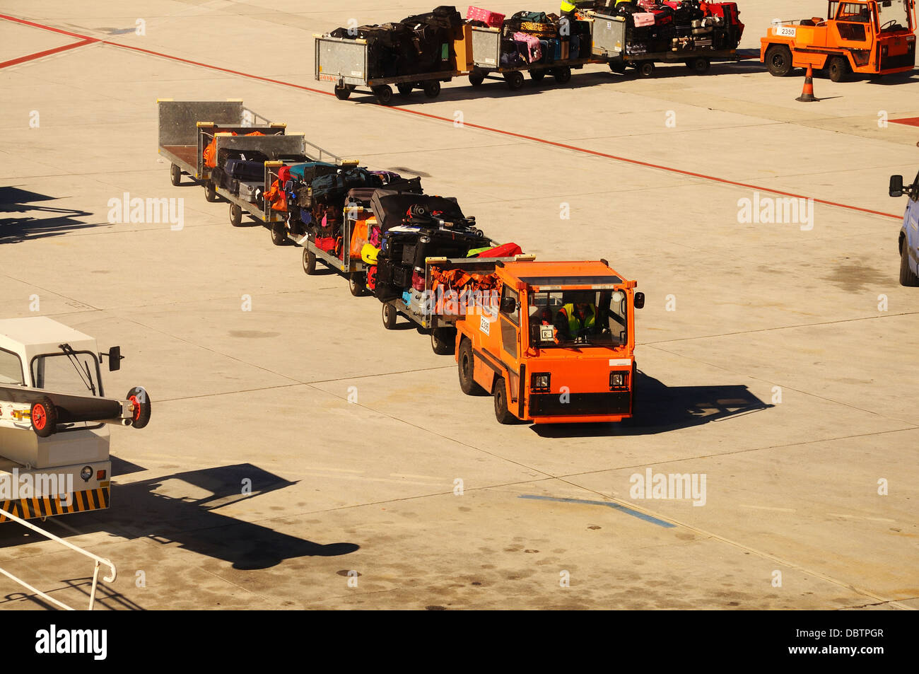 Baggage cart truck on the airport apron, Malaga, Andalusia, Spain, Western Europe. Stock Photo