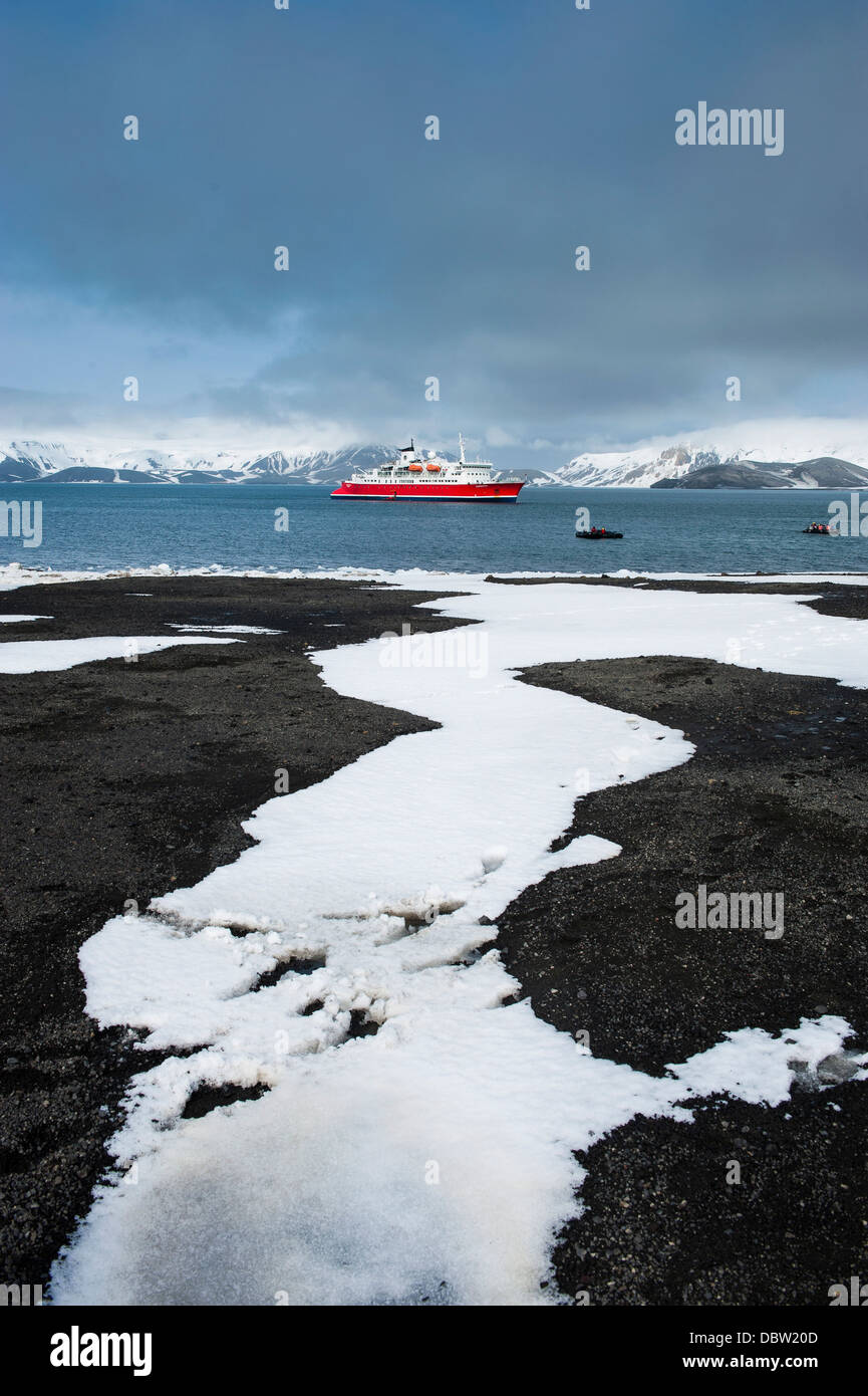 Cruise ship anchoring in the volcanic crater of Deception Island, South Shetland Islands, Antarctica, Polar Regions Stock Photo