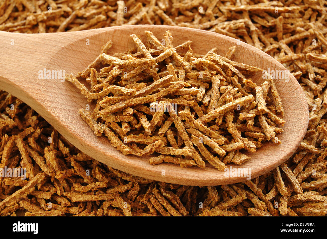 All Bran flakes breakfast cereal with wooden spoon Stock Photo