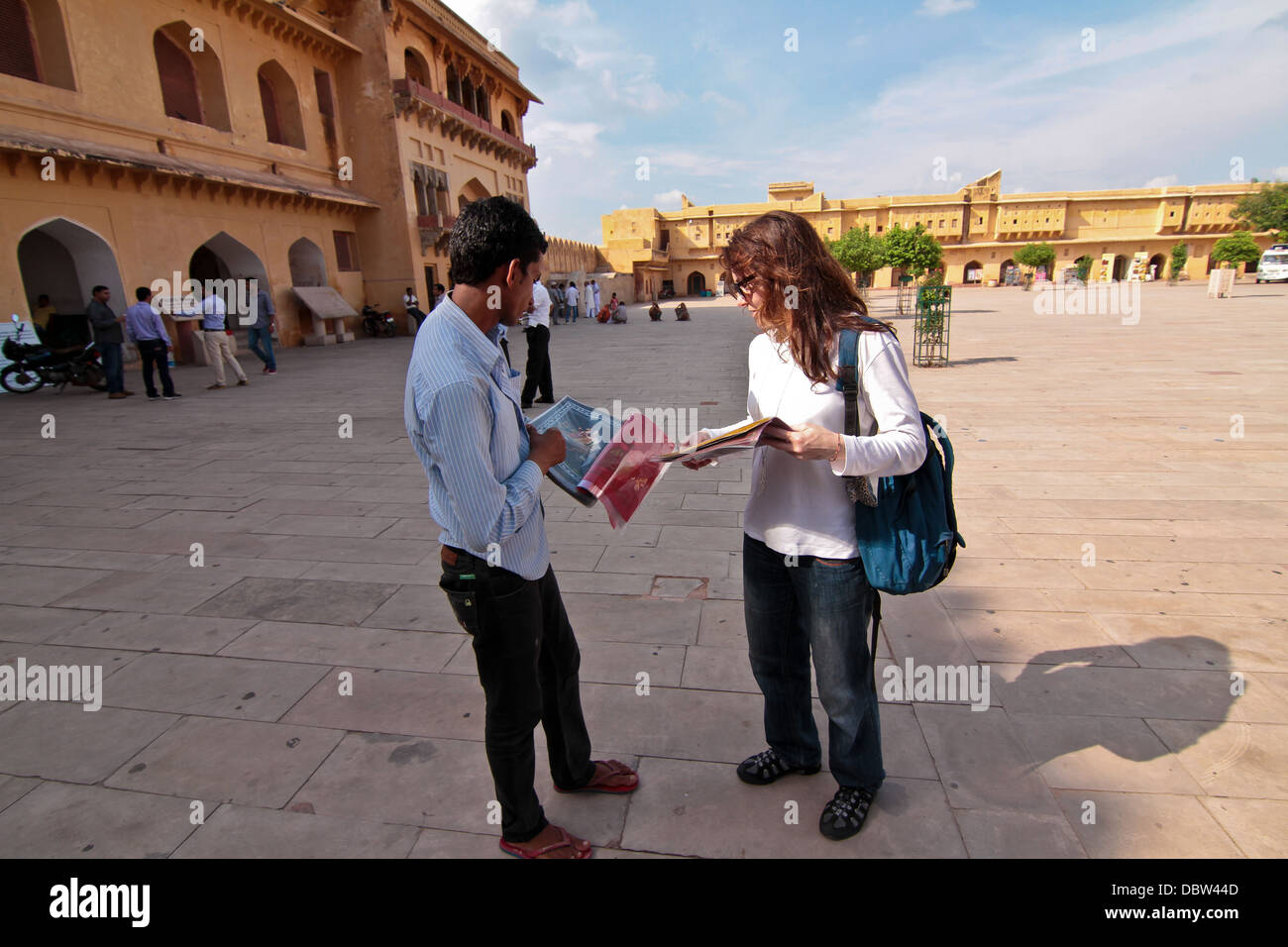 local selling postcards to western tourist inside Amer Fort in Amer Rajasthan India Stock Photo