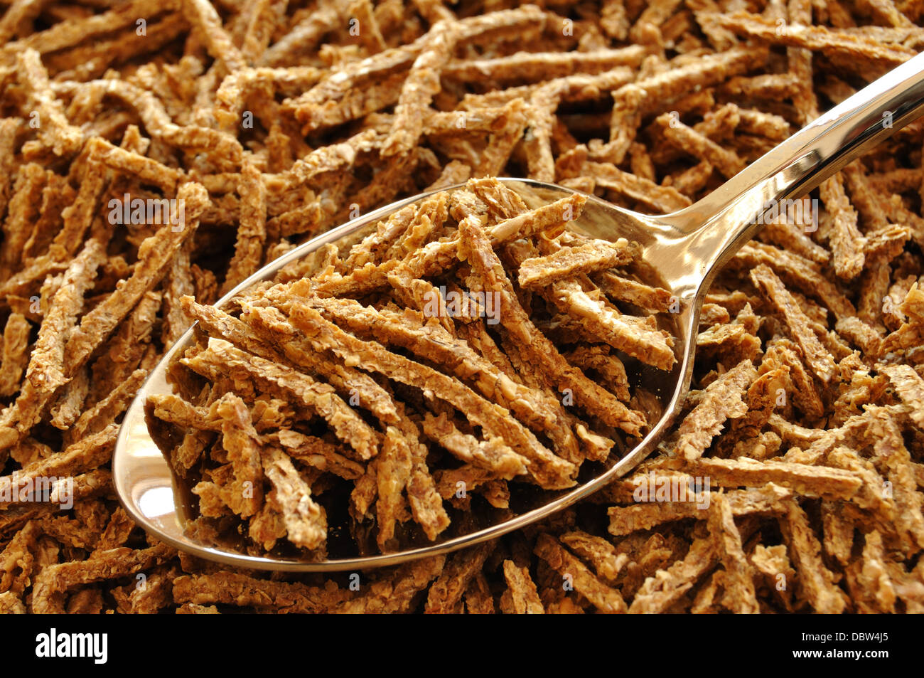 All Bran breakfast cereal with spoon Stock Photo