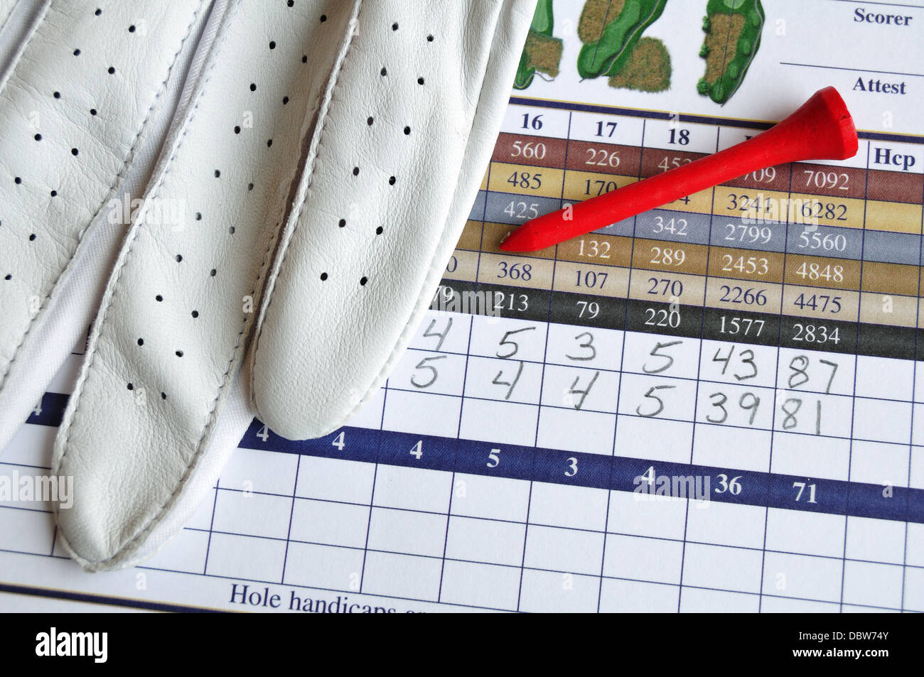Close up of Golf Score Card with Glove and Red Tee Stock Photo