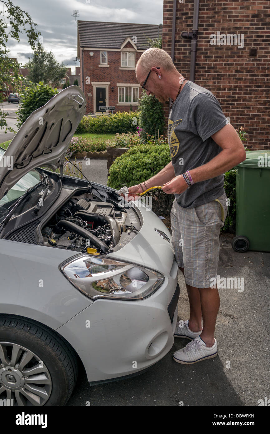 Adult man checking under the bonnet of car, Adult man checking under the hood of car Stock Photo