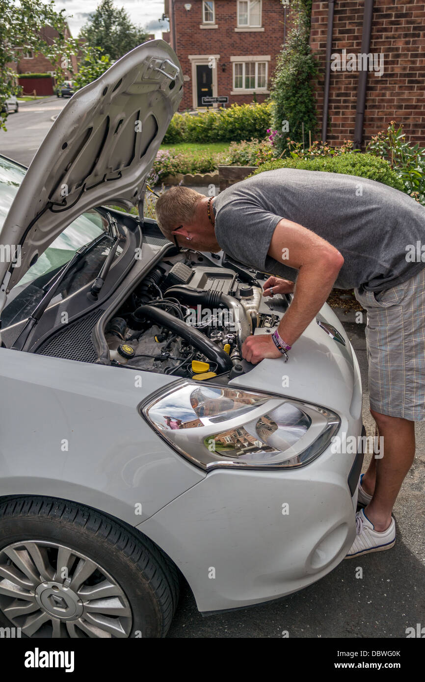 Adult man checking under the bonnet of car, Adult man checking under the hood of car Stock Photo