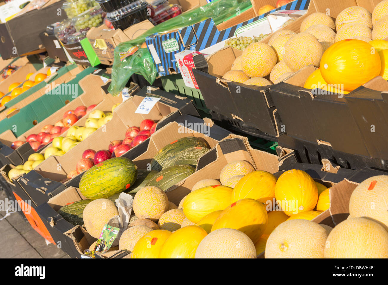 Melons (Galia, Honeydew and Watermelon types) and other fresh fruit being sold loose outside the