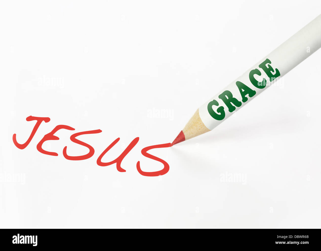 A Grace labeled pencil writing the word Jesus Stock Photo