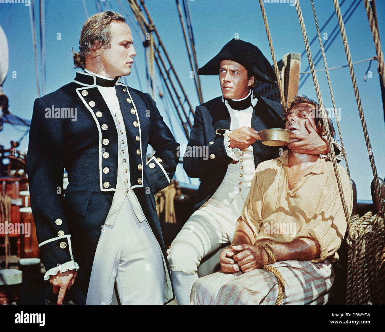 1960s 1962 MOTION PICTURE MUTINY ON THE BOUNTY MARLON BRANDO AS FLETCHER CHRISTIAN OBSERVES CRUEL PUNISHMENT OF SEAMAN SAILOR Stock Photo