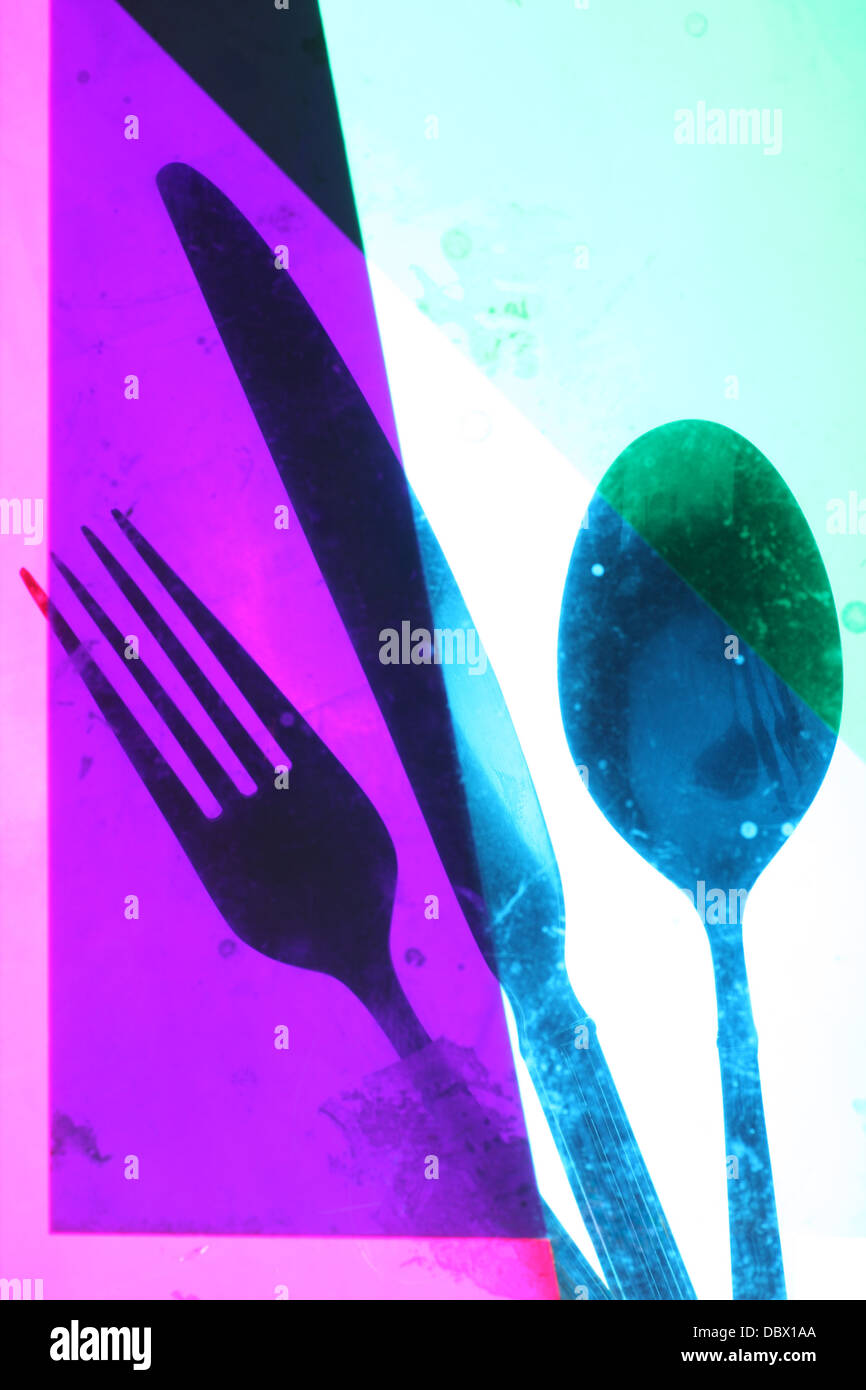 Cutlery taken behind coloured gels to create artistic image. imperfections of gels causing grunge effect. focus is on the image Stock Photo