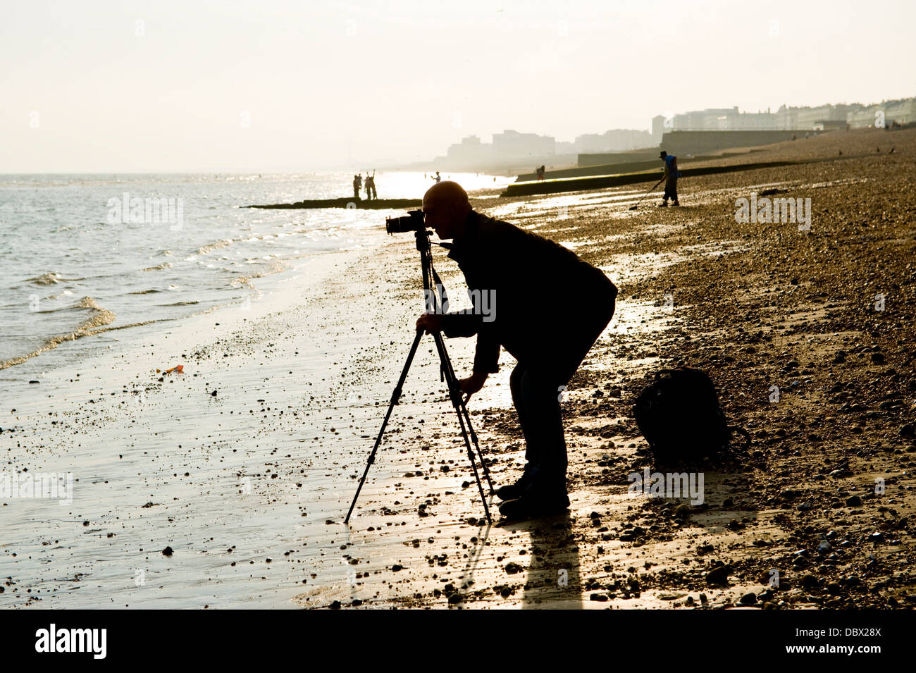 Photographer using camera and tripod on the beach in Brighton East ...