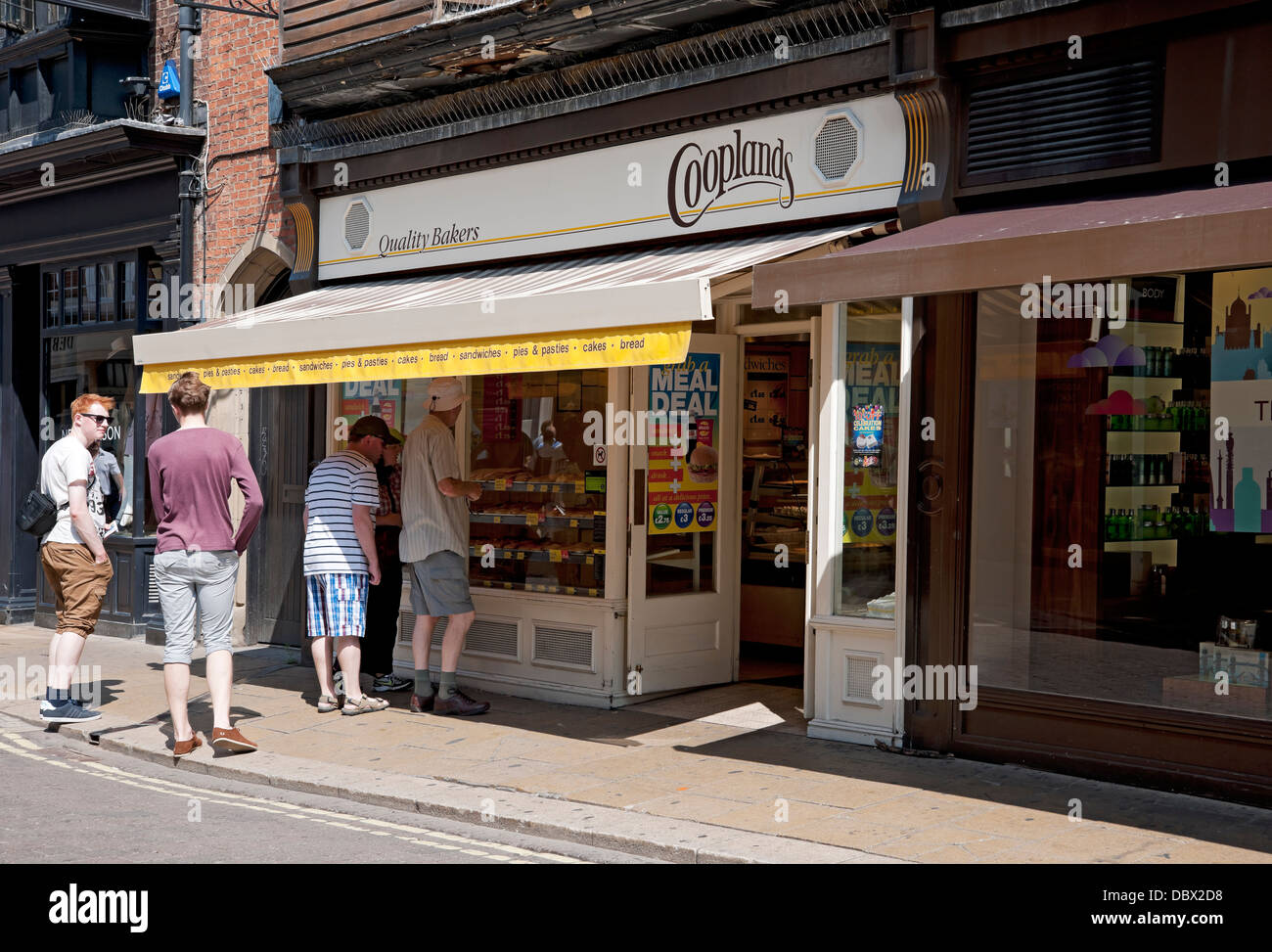 People looking at Cooplands bakery bakers shop store window exterior York North Yorkshire England UK United Kingdom GB Great Britain Stock Photo