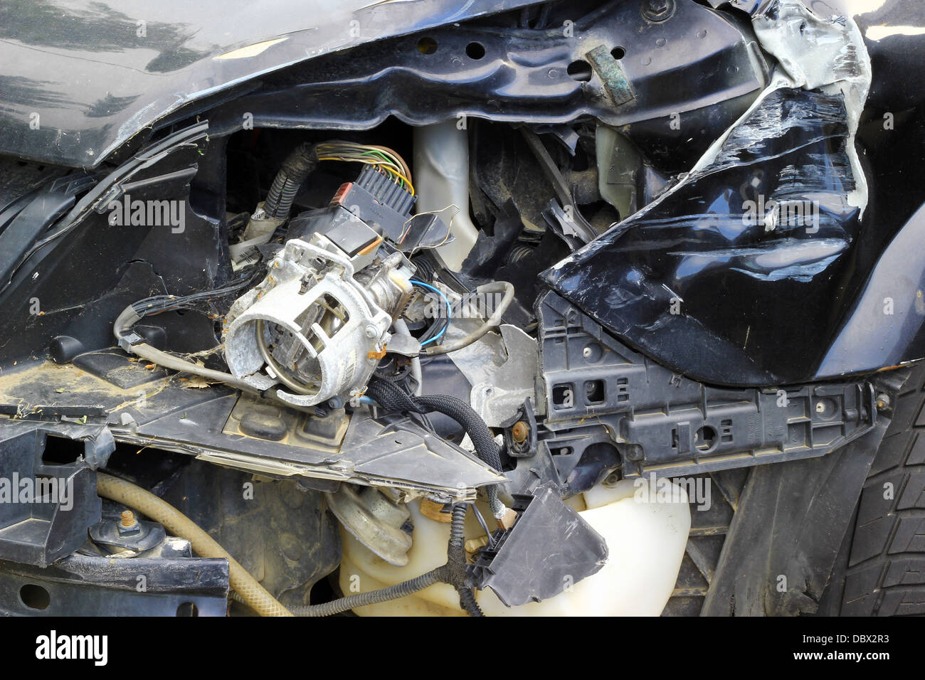 Crashed car close up. The front part is severely damaged. Stock Photo