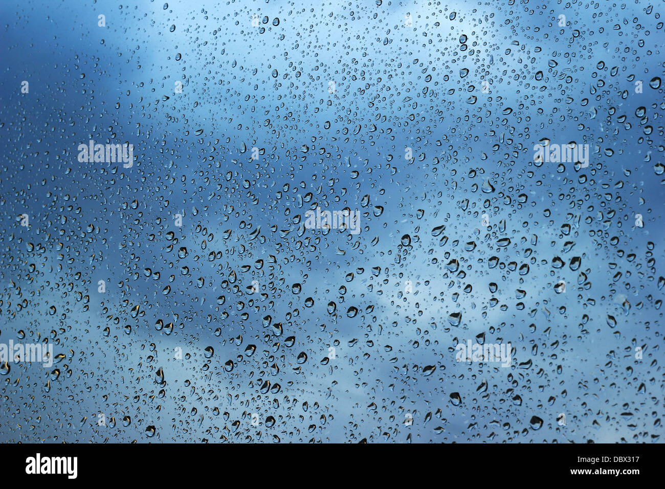 Water drops on window with dark clouds in the background Stock Photo ...