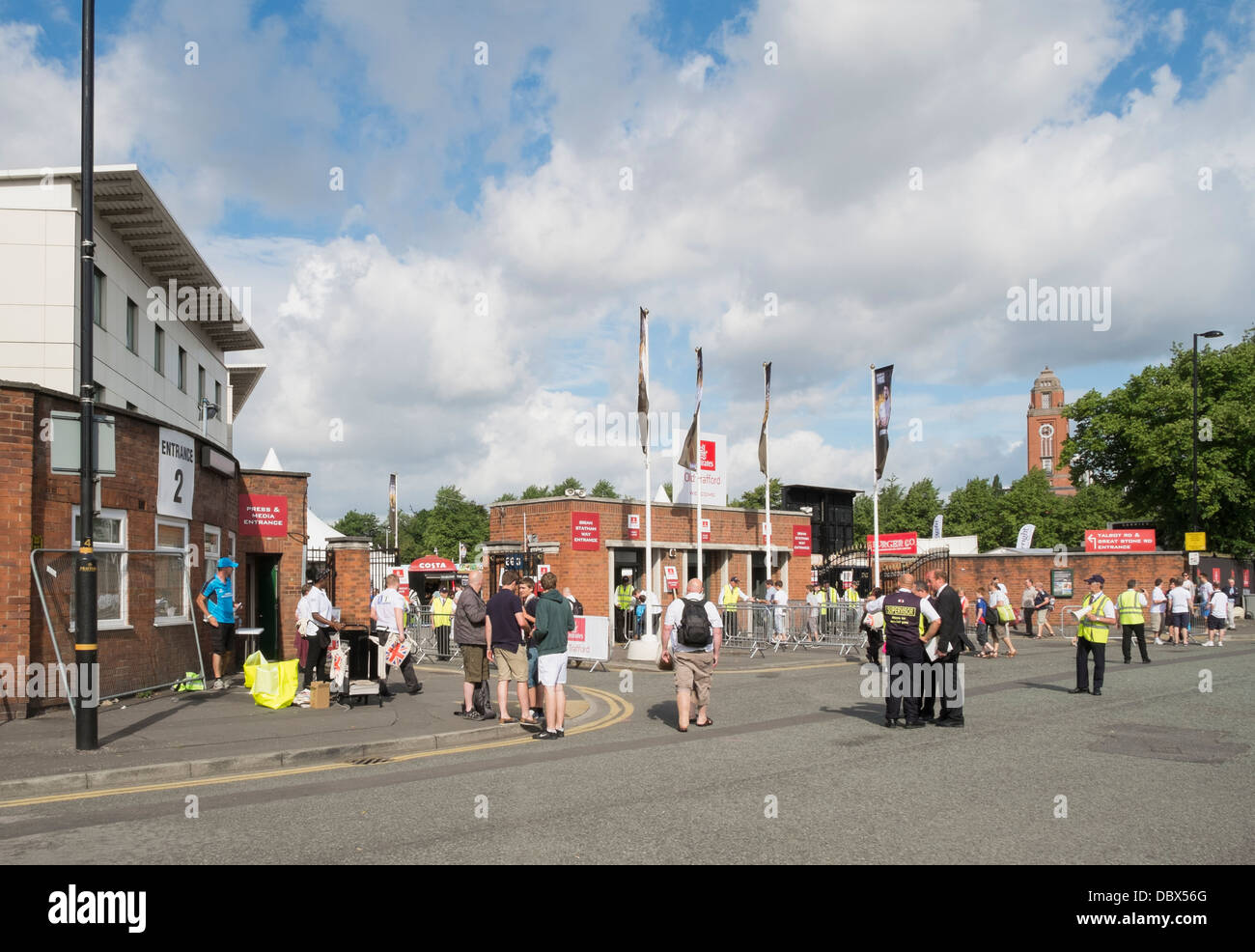 People arriving at Brian Statham Way entrance to Emirates Old Trafford at Lancashire County Cricket Ground for Ashes Test Match Stock Photo