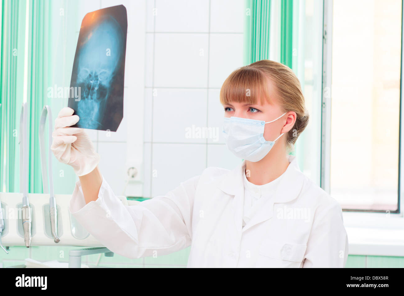 Young woman doctor looks at an X-ray of skull Stock Photo