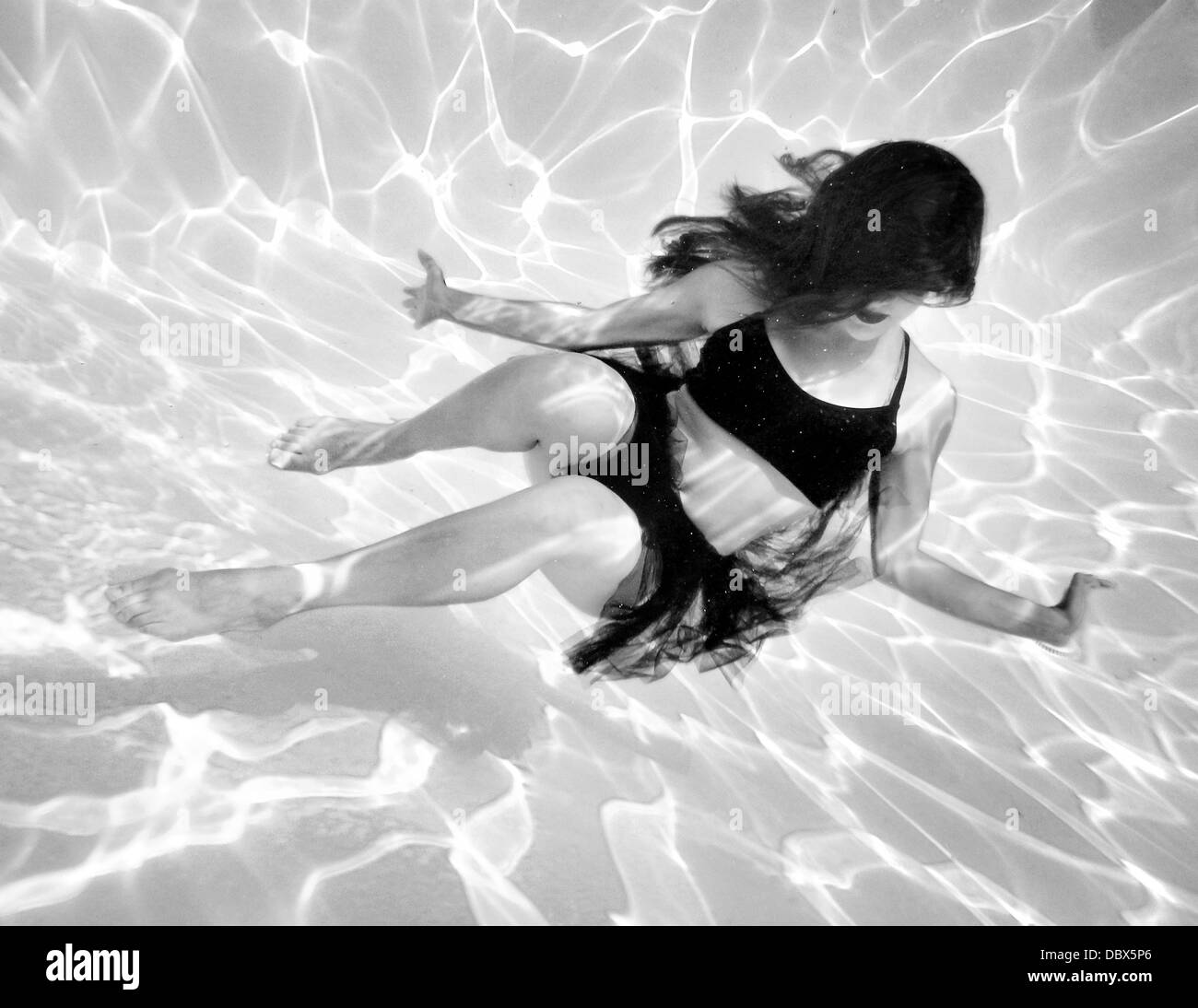 Underwater fashion photograph of a model and dancer in the water Stock Photo
