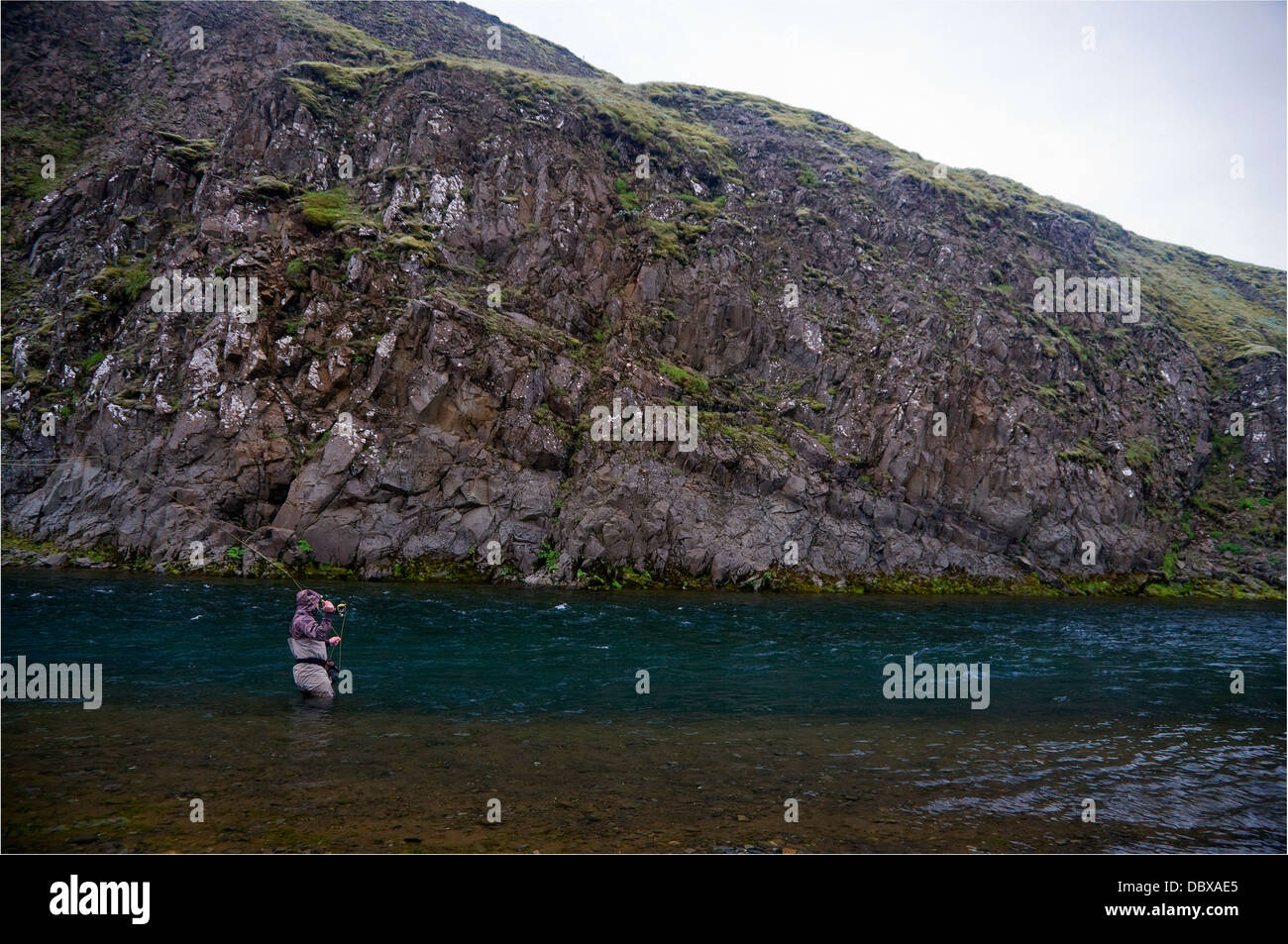 A fly fisherman casts for salmon on one of Iceland's most-productive, scenic rivers. Stock Photo