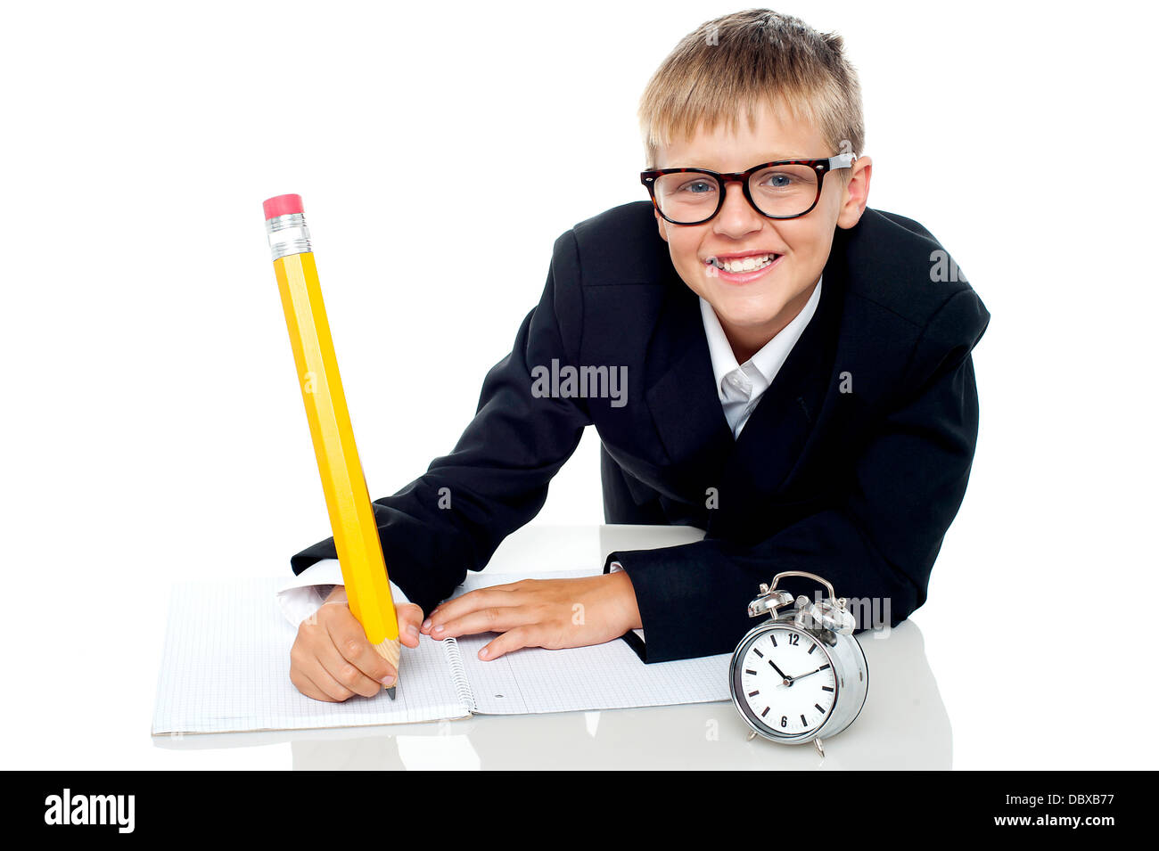 Casual shot of a school kid finishing his assignment in time Stock Photo