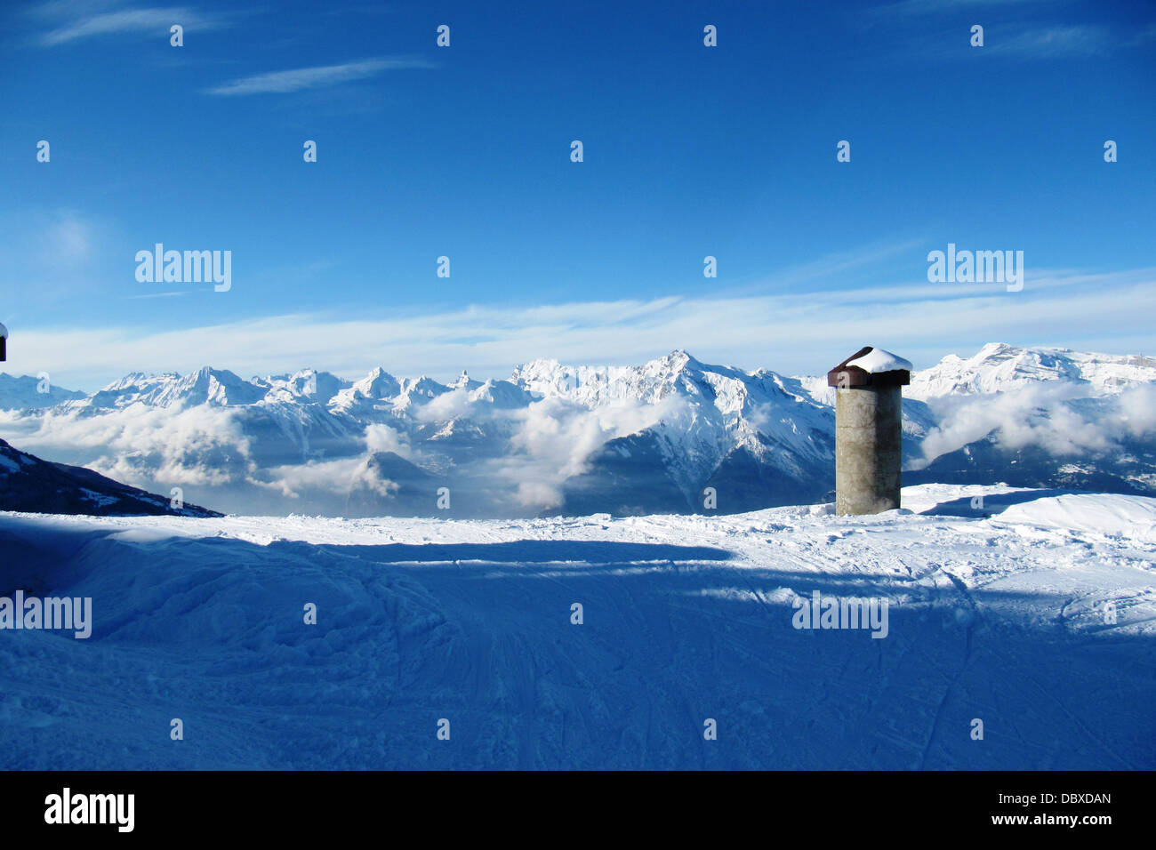 winter alpine mountain scene under a blue sky Stock Photo - Alamy
