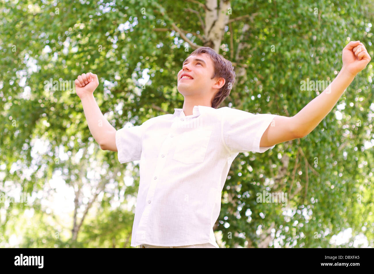 young man looking to the sky, holding his hands up Stock Photo - Alamy