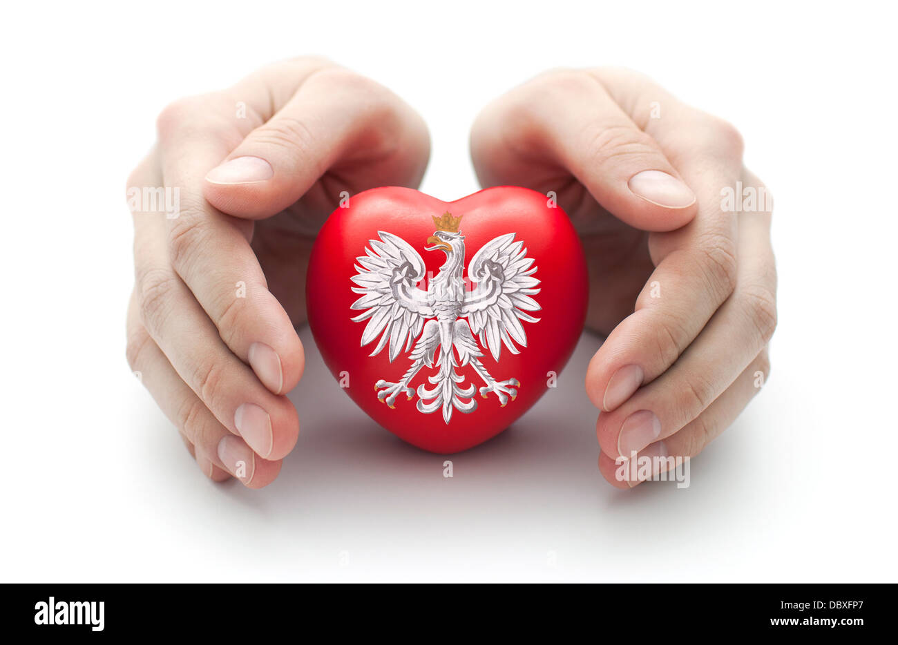 Hands covering Polish coat of arms on a red heart Stock Photo