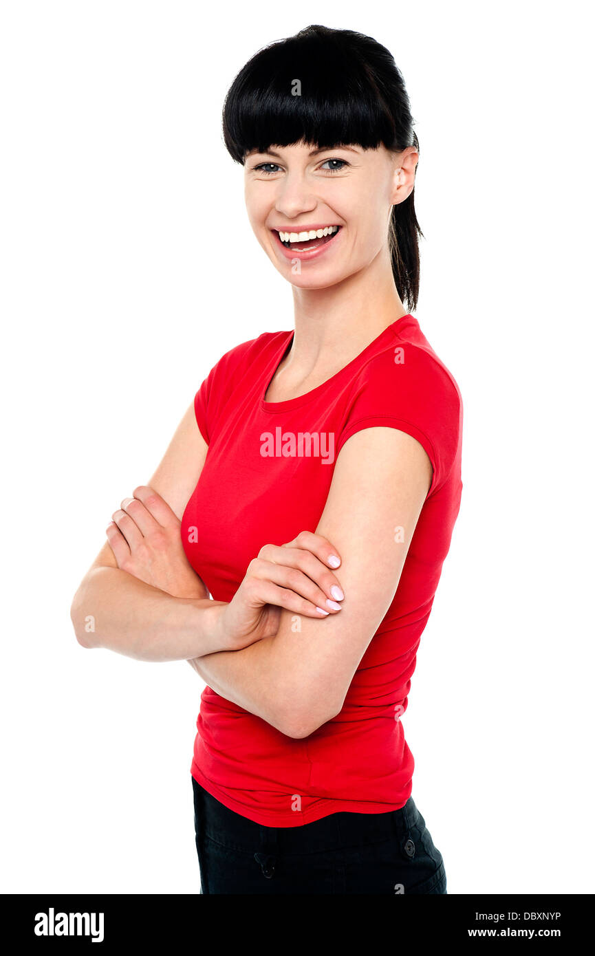 Pretty slim lady in bright red top, arms folded Stock Photo Alamy