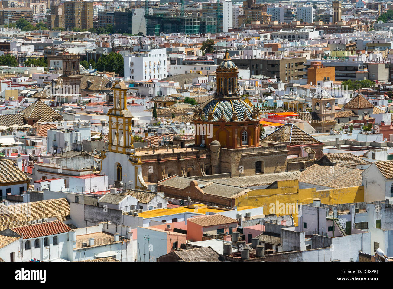 The church 'Santa Cruz' merging from roofs, seen from the 'Giralda, Seville, Spain. Stock Photo