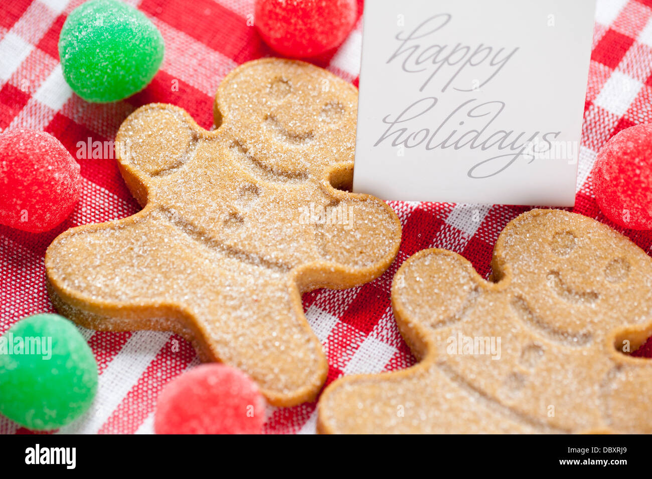 cropped image of gingerbread candies with happy holidays tag Stock Photo