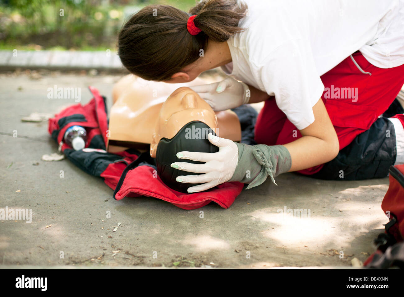 CPR practitioner examining airways on dummy Stock Photo