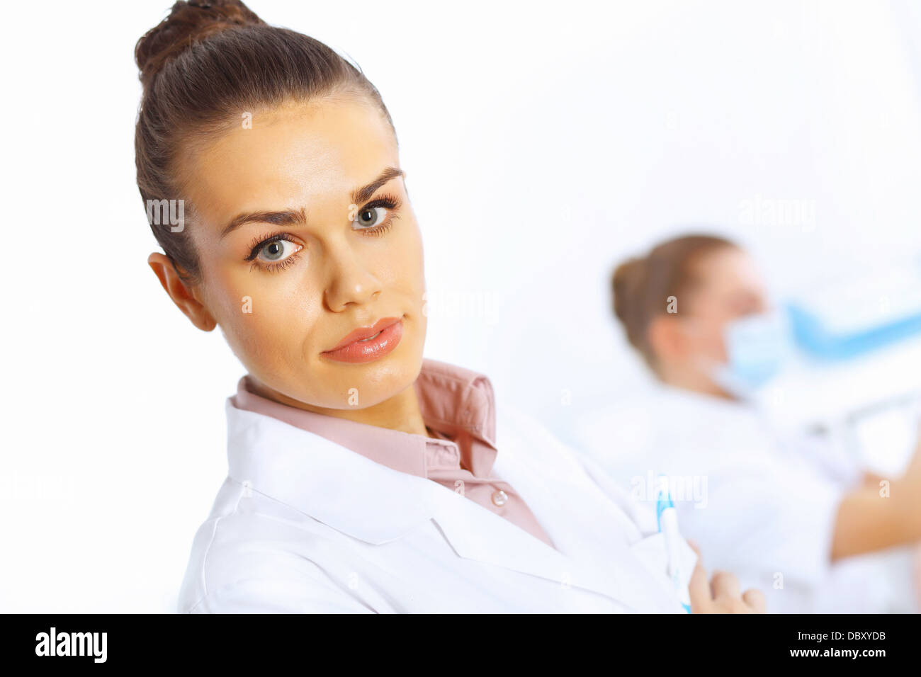 Young female doctor in white uniform Stock Photo - Alamy