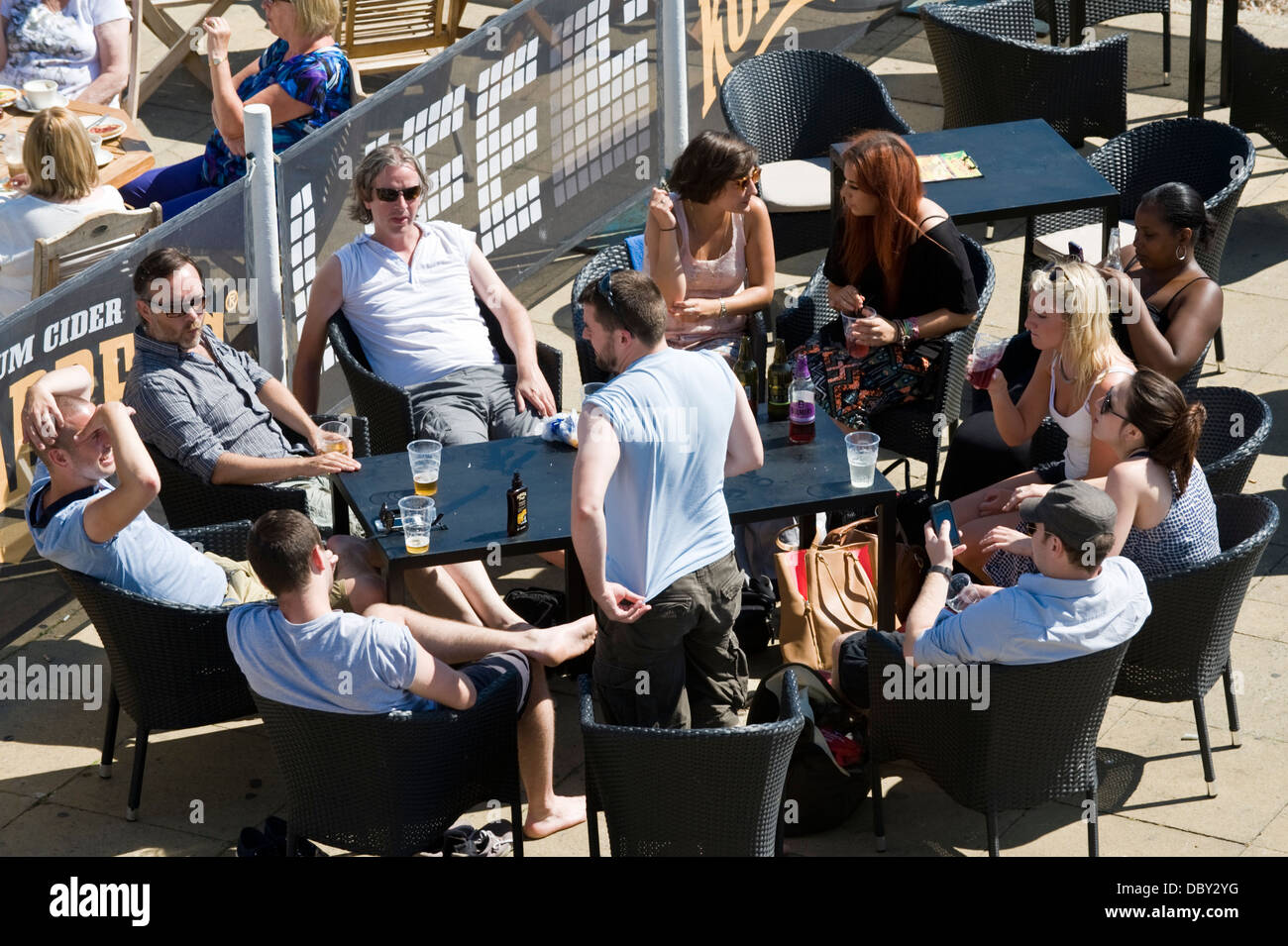 People drinking and relaxing outside bar on the seafront in Brighton East Sussex England UK Stock Photo