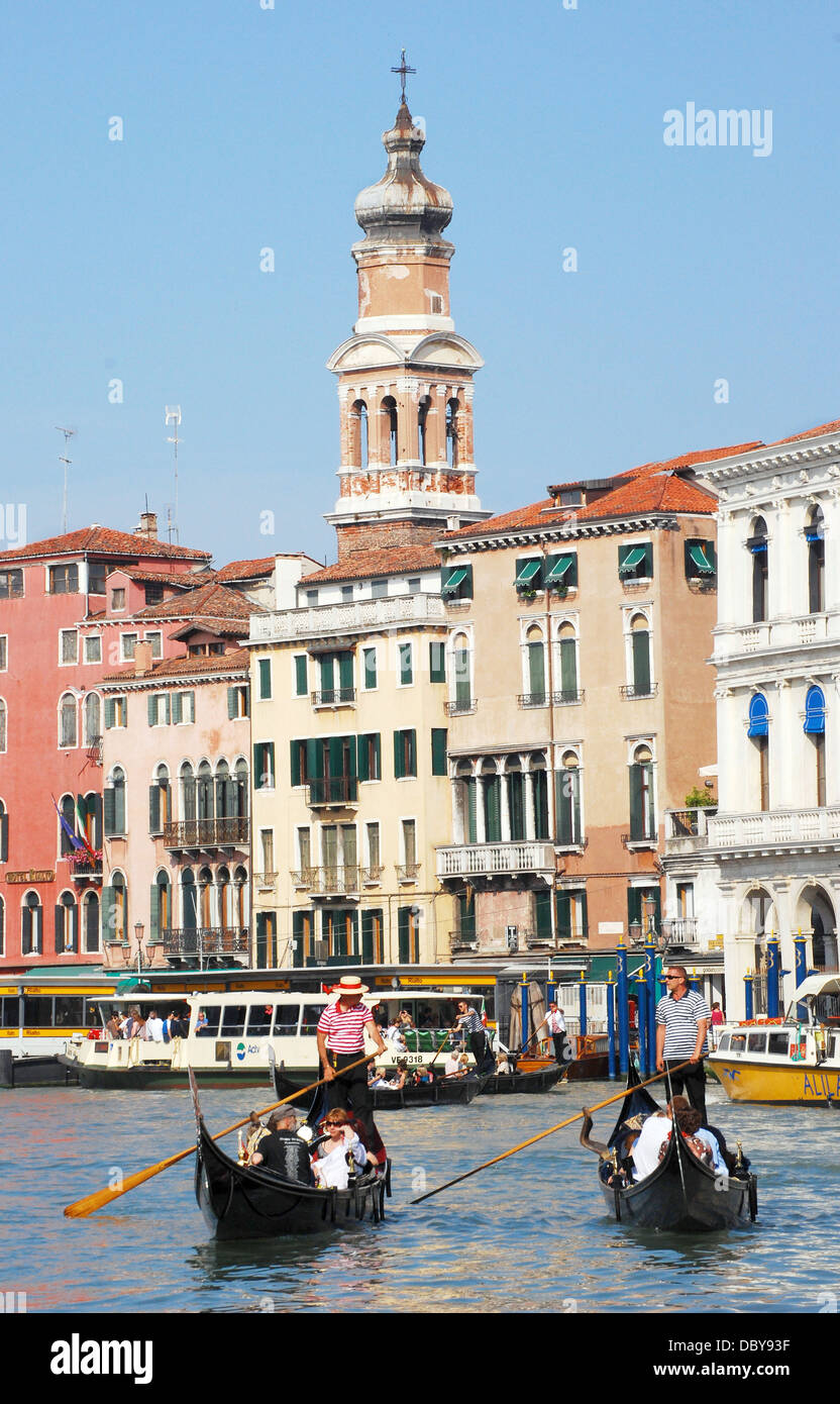 Vaporetta view of 2 gondolas on the Grand Canal just past the Rialto Bridge in Venice, Italy. The gondoliers are conversing Stock Photo