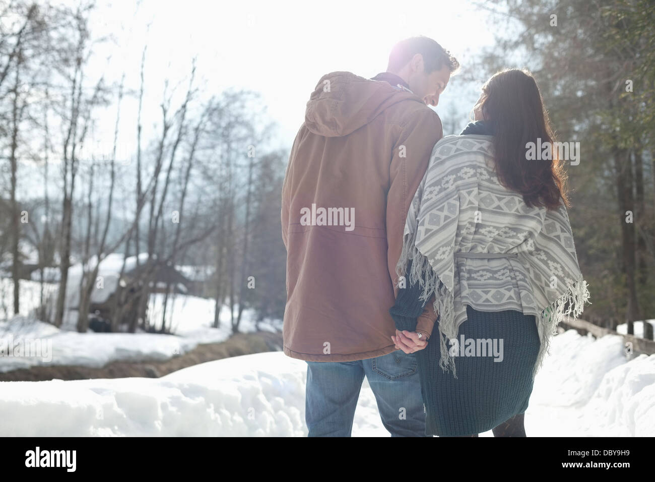Couple holding hands and walking in snowy lane Stock Photo - Alamy
