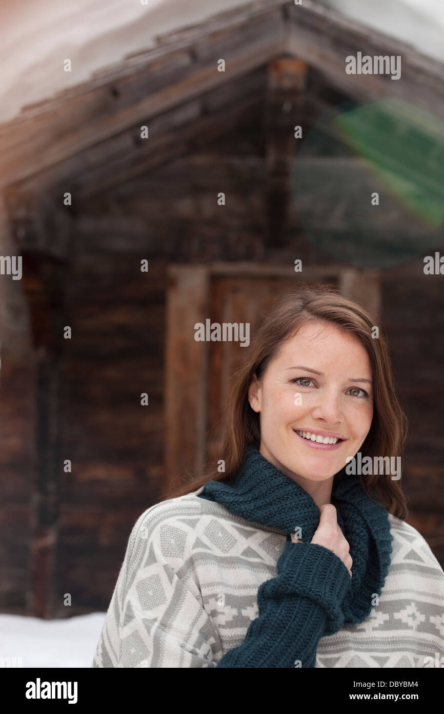 Portrait of smiling woman in snow outside cabin Stock Photo - Alamy