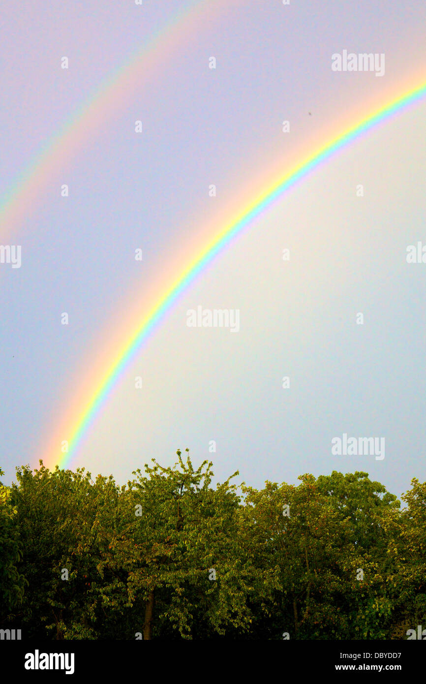 Rainbow in a clear sky over the English countryside Stock Photo Alamy