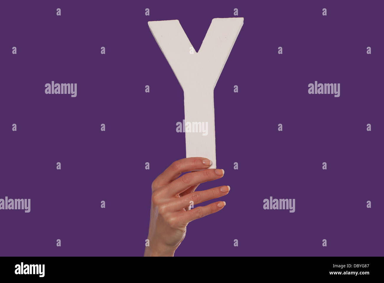 Female hand holding up the letter Y from the bottom Stock Photo - Alamy