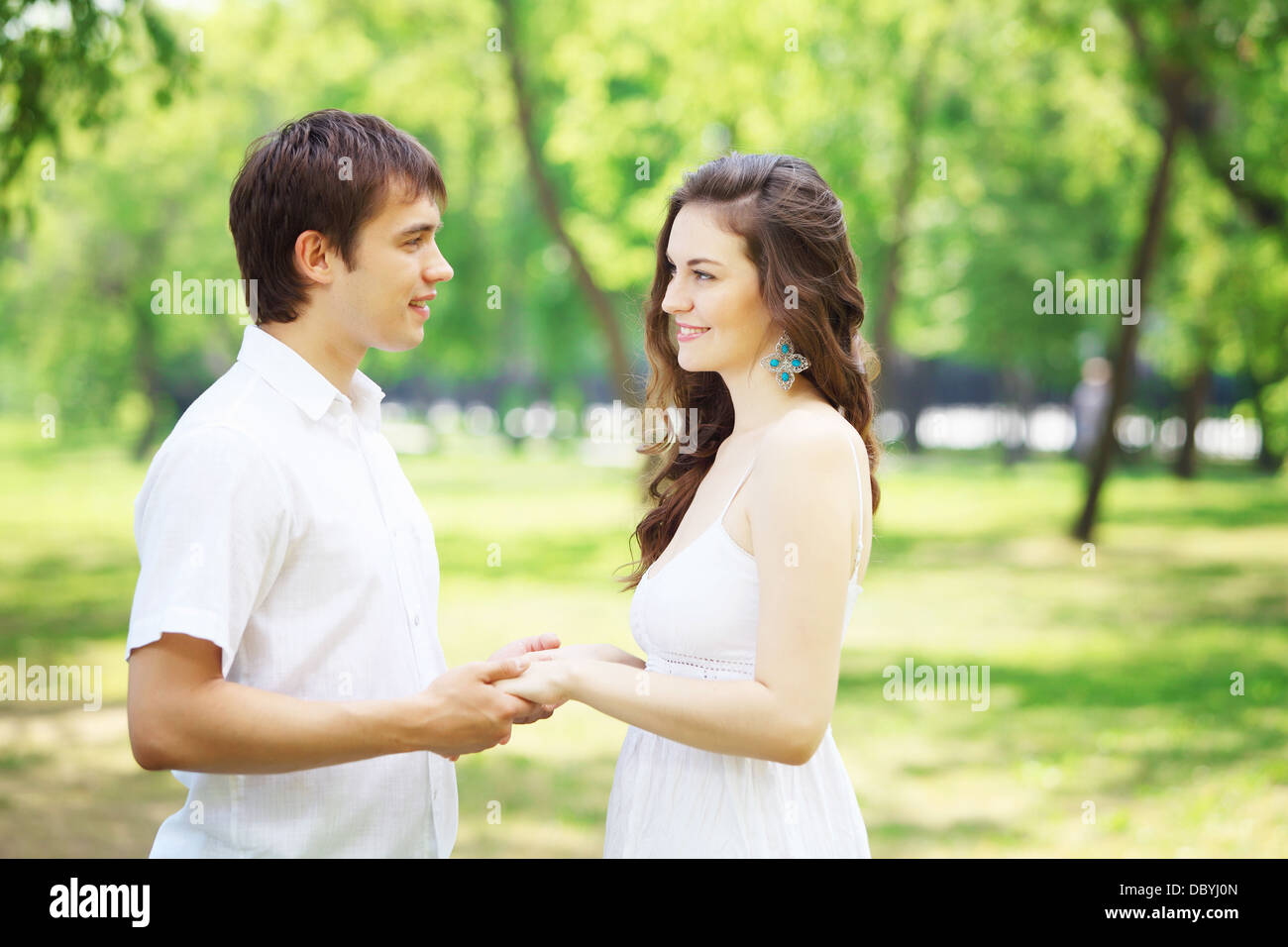 Young love Couple smiling under blue sky Stock Photo - Alamy
