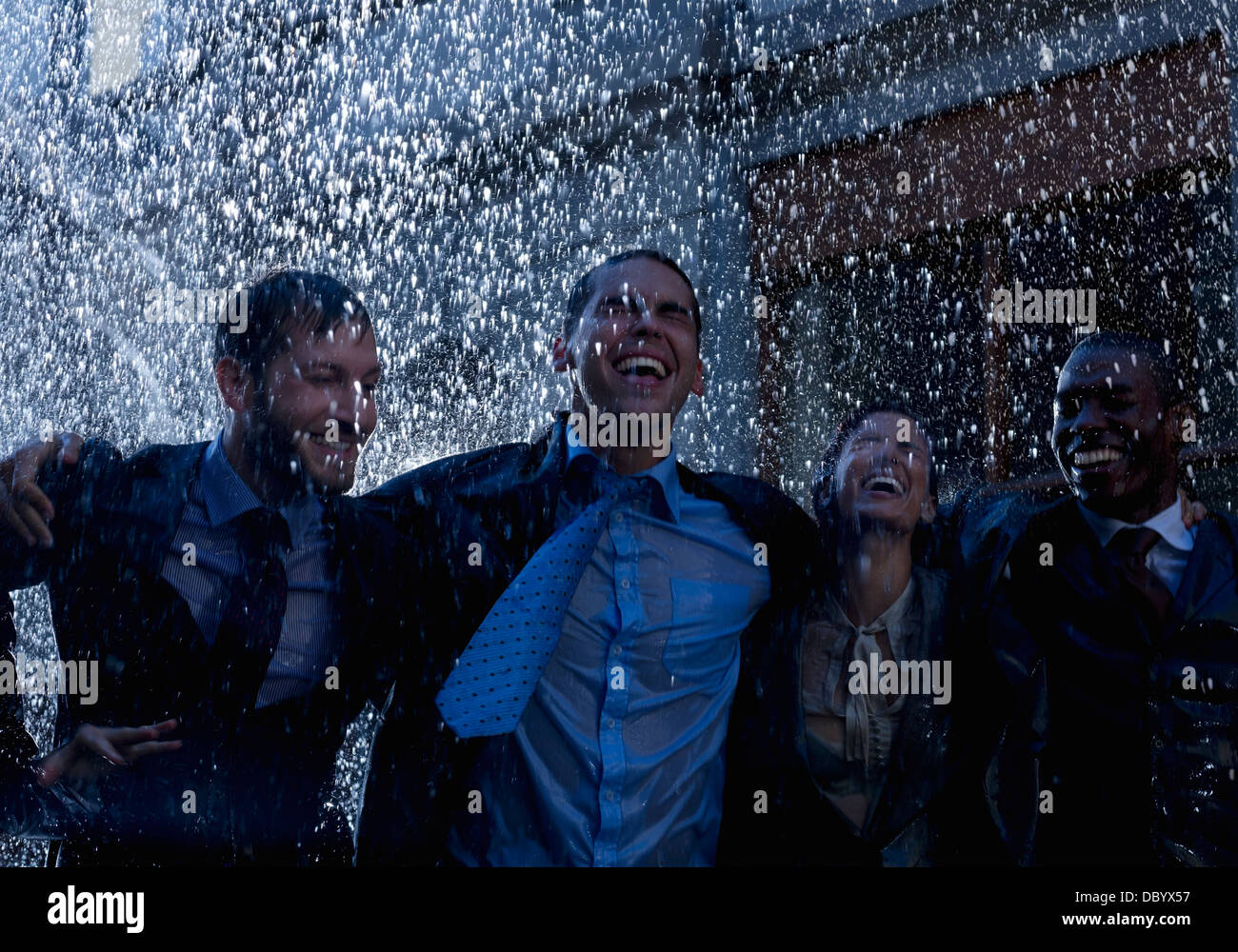 Enthusiastic businessmen in rain Stock Photo