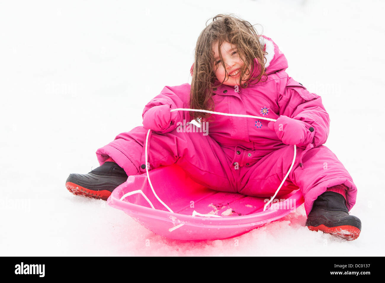 A young girl is ready to toboggan at Lake Mountain in Victoria