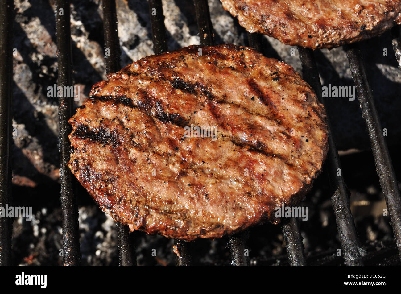 Burgers on a BBQ Stock Photo
