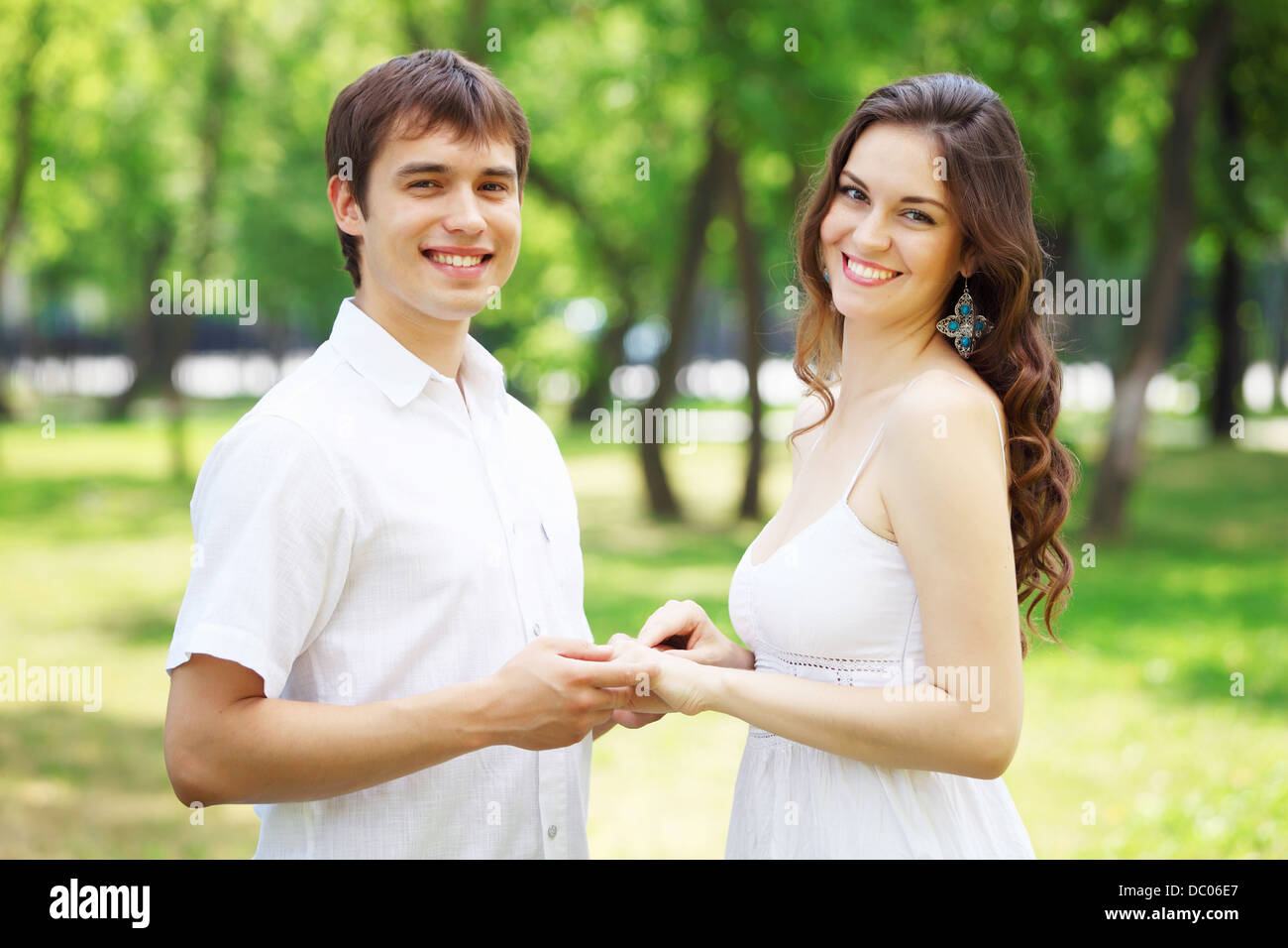 Young love Couple smiling under blue sky Stock Photo - Alamy