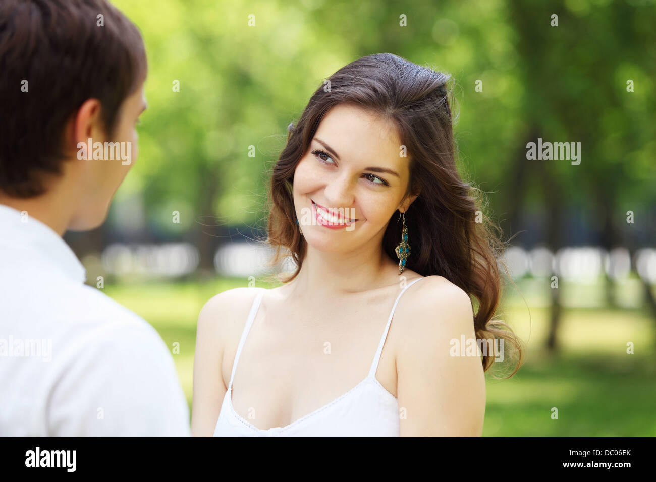 Young love Couple smiling under blue sky Stock Photo - Alamy